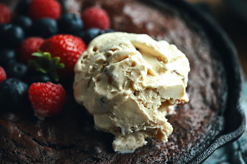 Chocolate Brownie Baked in a Pan and Served with Berries and Ice Cream