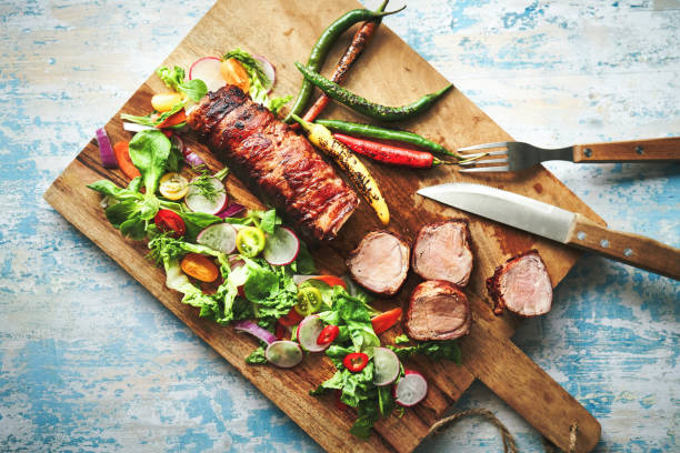 istock Roasted Pork Filet with Bacon and Green Salad 1405670035