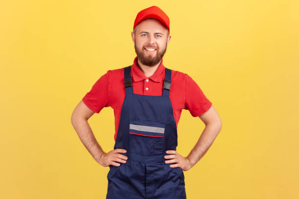 istock Worker man standing with hands on hips, looking at camera, being ready to take and complete order. 1405670041