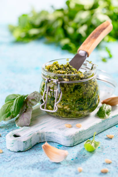 istock Fresh basil pesto sauce in glass jar. 1405670423