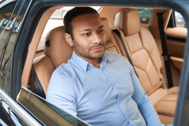 istock Pensive young man seated in luxury car 1405671186