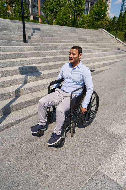 istock Disabled man going down stairs in wheel chair 1405671418