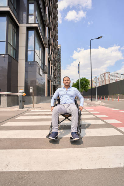 istock Disabled man in manual wheelchair on zebra crossing 1405671476
