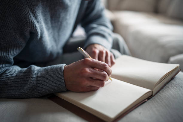 istock Man making notes with pencil and paper close up. 1405672823