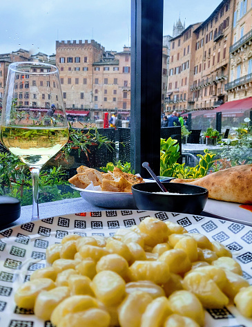 Potato gnocchi,parmesan,bread and white wine. Town square, Siena, Italy