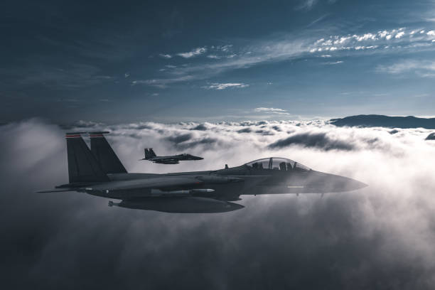 istock Jet fighters flying over the clouds. 1405675561