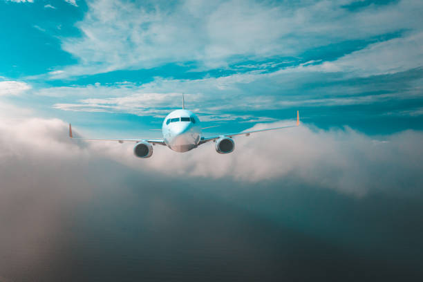 Commercial Jet airplane flying over clouds.