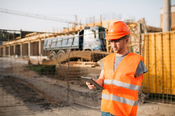 Construction site foreman using a digital tablet computer stock photo
