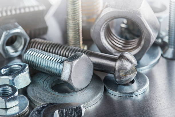 istock set of different nuts, bolts, screws, washers and drill bits,thread tap and mill cutters on steel plate background. Locksmithing deal. 1405676907