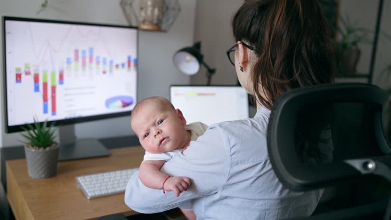 Multi taking woman working remotely and taking care of newborn baby son.