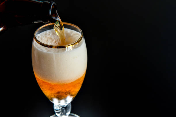 istock filling beer glass on black background 1405679656