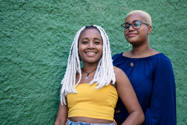 istock Lesbian couple smiling in  green background 1405679989