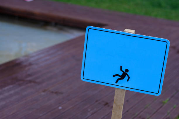 caution wet floor warning sign near swimming pool in hotel. stock photo