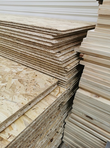 OSB sheets are stacked in a hardware store. The building material with wood.