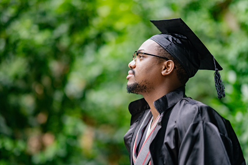 A Black ethnic student is celebrating his graduation.