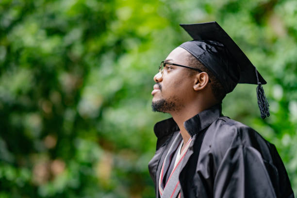 Black ethnic student celebrating his graduation A Black ethnic student is celebrating his graduation. graduation man stock pictures, royalty-free photos & images