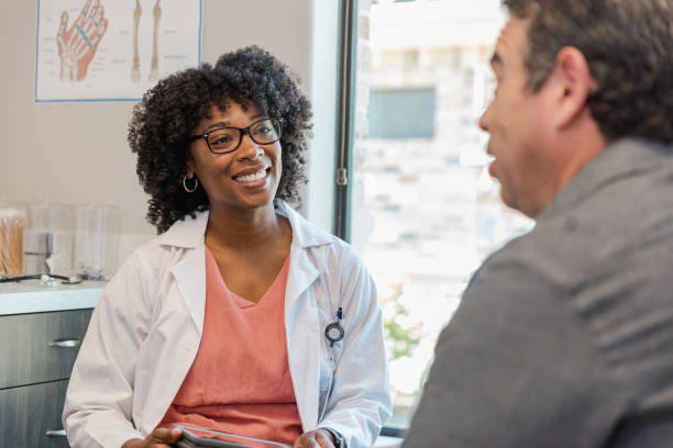 istock Female nurse practitioner smiles and makes eye contact with patient 1405683427