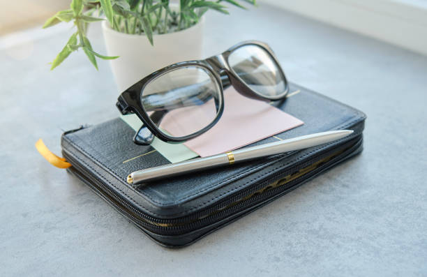 A picture of glasses perched on a Bible.