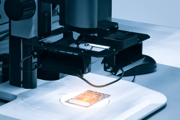 istock Chip testing equipment. Manufacturing of microchips. A close-up study of a test sample of a transistor chip under a microscope in the laboratory. Automation of production. 1405684847