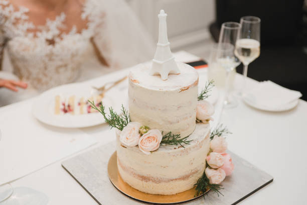 istock Beautiful wedding cake decorated with fresh flowers and greenery. 1405687349