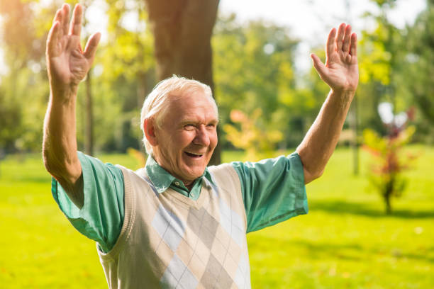 istock Senior man with raised arms. 1405688026
