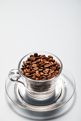 Coffee beans in\n transparent cup. Stock photo