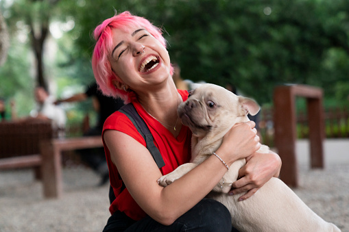 Young Woman cuddles her dog