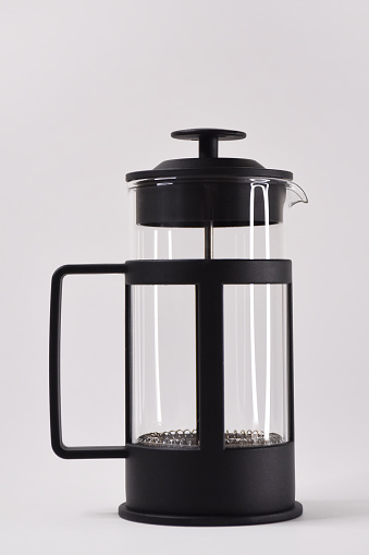 Empty French press on the white background