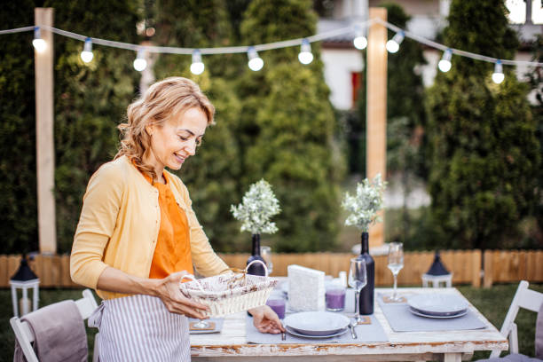 istock Woman serving outdoor party table 1405691600