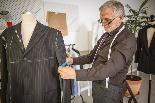 Photo of experienced tailor working on local business