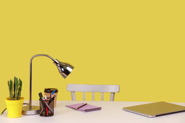 istock Empty workplace, paper cup of coffee, notepad with pencil lying on table near closed laptop. 1405695148