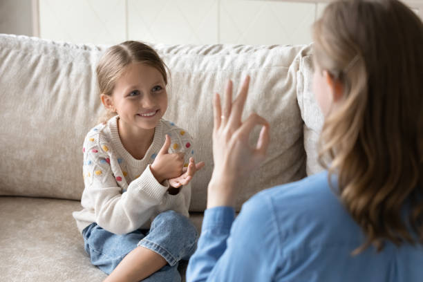 istock Happy little kid using sign language, communicating with mother. 1405695806