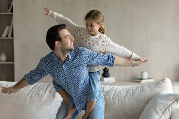 istock Happy family playing entertaining game at home. 1405695816
