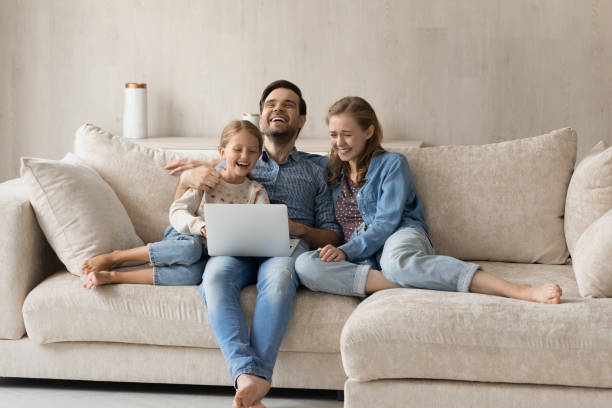 istock Bonding family watching funny movie on computer. 1405696139