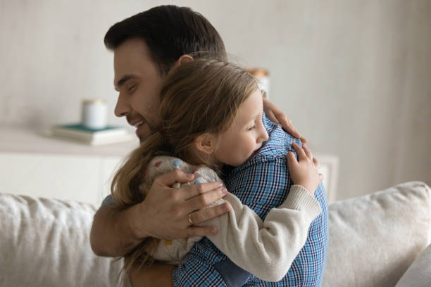 istock Happy loving young father cuddling small daughter. 1405696146