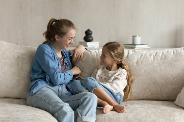 istock Relaxed happy bonding family talking, sitting on couch. 1405696160