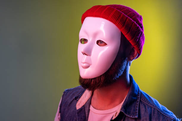istock Anonymous hipster man in white mask on face, hiding his identity, spying undercover, corruption. 1405696187
