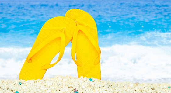 Stylish blue flip flops on yellow background, top view. Space for text