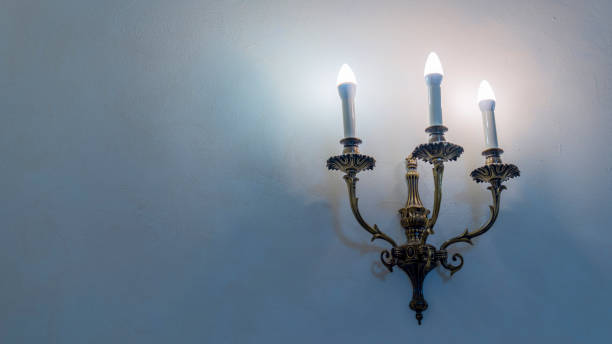 istock Vintage wall lamp. Space for text. Lamp light on the wall. Working lamps at dusk. 1405703296