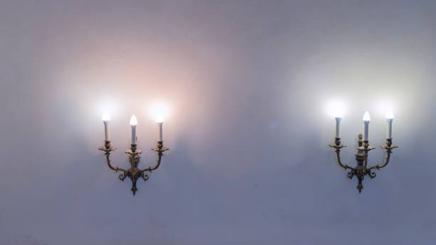 istock Vintage wall lamp. Space for text. Lamp light on the wall. Working lamps at dusk. 1405703297
