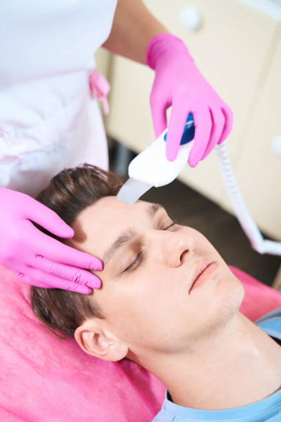 istock Calm man relaxing during beauty procedures in clinic 1405704031
