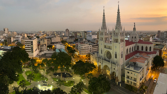 General landscape view of Guayaquil's Cathedral at Guayaquil's Downtown, Guayas Province, Ecuador, South America.\n\nThe Metropolitan Cathedral of Guayaquil is a cathedral in the center of Guayaquil, Ecuador. The current cathedral is the successor of the cathedral that was Guayaquil's main cathedral at the time of the city's founding. The original cathedral was made of wood and located on Santa Ana Hill.\n\nGuayaquil is a port city in Ecuador, known as a gateway to Pacific beaches and the Galapagos Islands. Stretching along the Guayas River is the waterfront Simón Bolívar promenade, home to La Rotonda monument. In the north, Las Peñas is a neighborhood full of colorful houses. Stairs lined with cafes and art galleries lead up Santa Ana Hill, site of Santa Ana chapel, a lighthouse and views of the city.