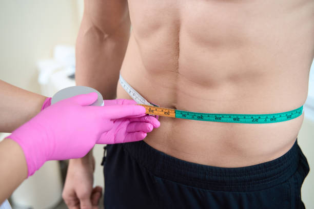 istock Beauty doctor examining male torso before procedures 1405704167