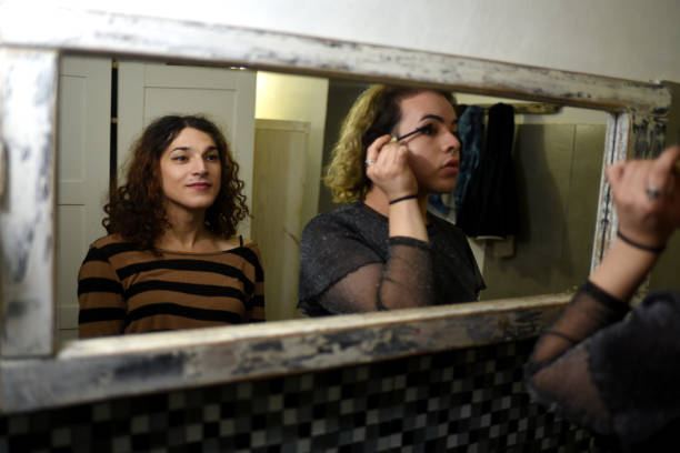 istock friends putting on makeup in the mirror 1405706991