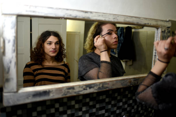 istock friends putting on makeup in the mirror 1405706994