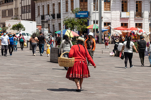 Portrait of male farmer holding a crate full of strawberries at the marketplace.