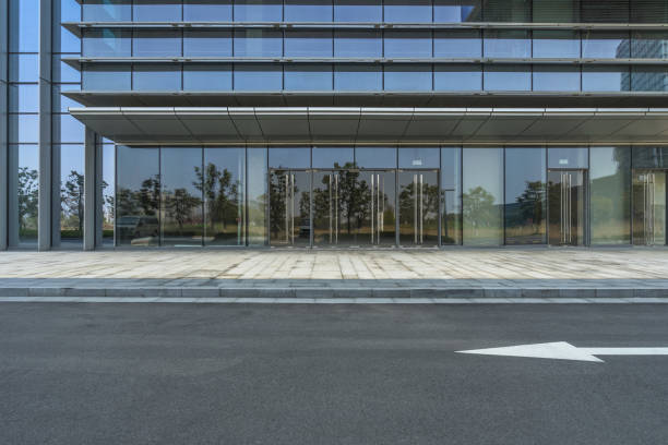 istock empty asphalt road near glass office building 1405722257