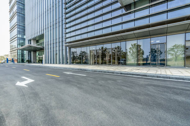 istock empty asphalt road near glass office building 1405722258