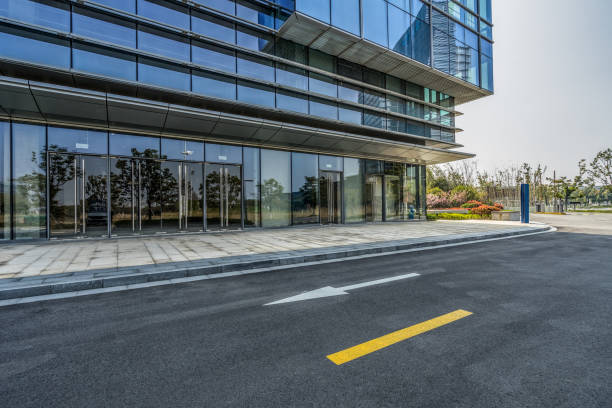 istock empty asphalt road near glass office building 1405722263