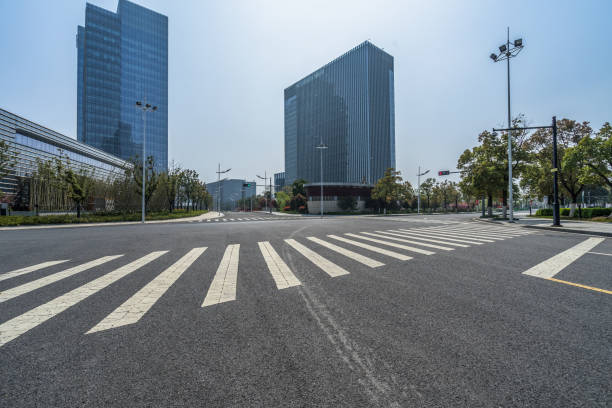 istock empty road with zebra crossing and skyscrapers in modern city 1405722274